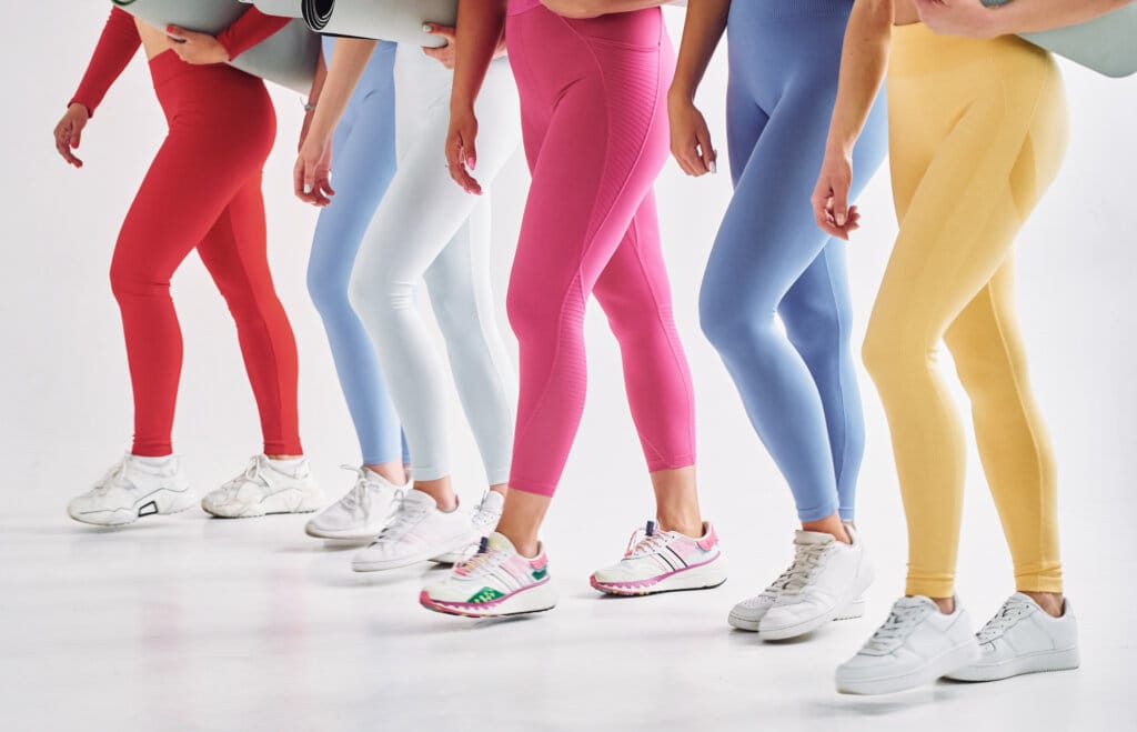 Side view. Women in sportive clothes is indoors in the studio